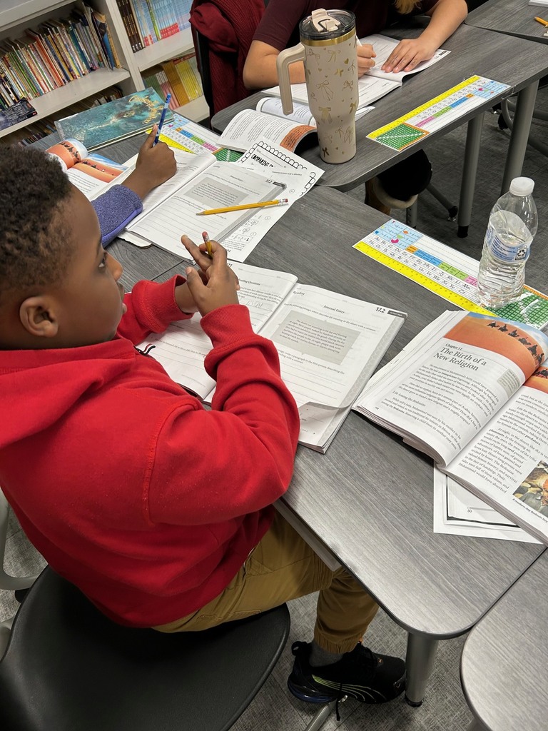 Fourth grade students use the text to answer comprehension questions.
