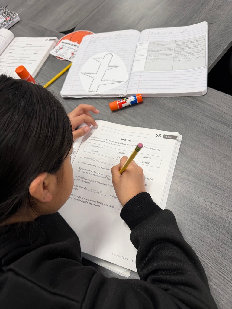 Students using their interactive notebook to complete an activity page in CKLA.