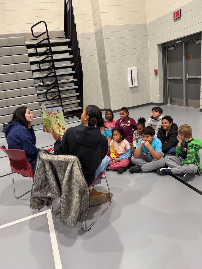Third grade students enjoying a read aloud.