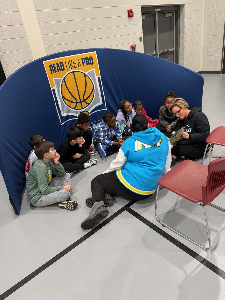 Third grade students enjoying a read aloud.