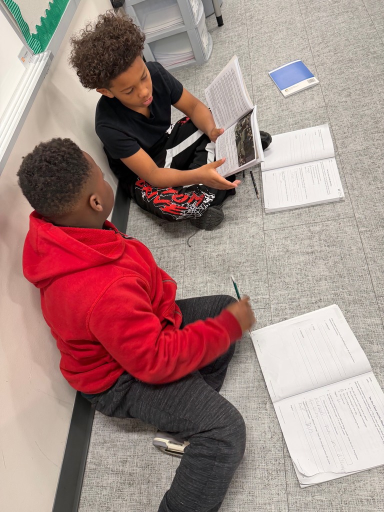 4th grade students working together to answer comprehension questions using their CKLA reader.