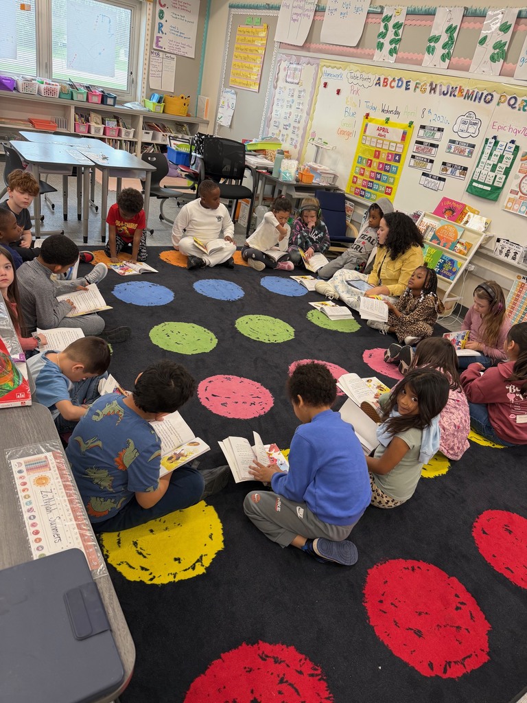 1st grade students reading their CKLA reader and answering questions about the story together.