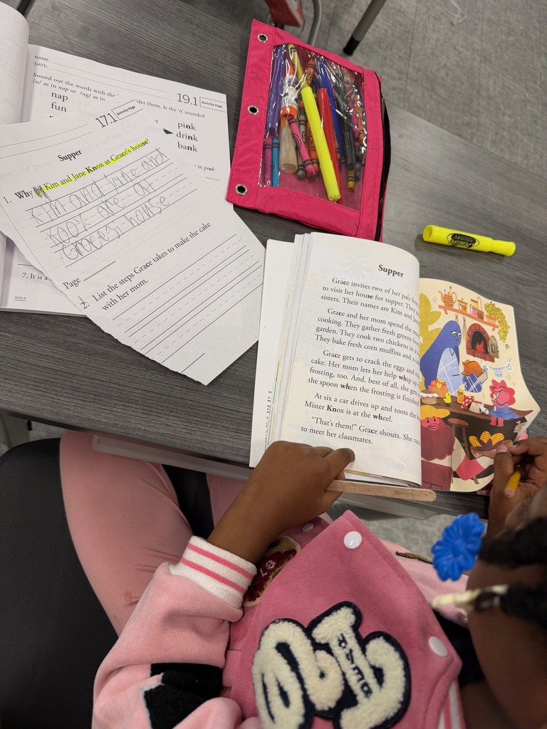 1st grade student checking the story for evidence.