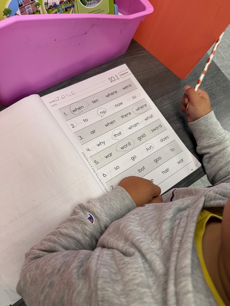 Kindergarten students finding the correct tricky word read aloud by the teacher.