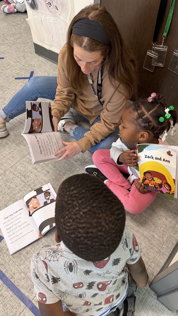 Students are reading with their teacher in a small group.