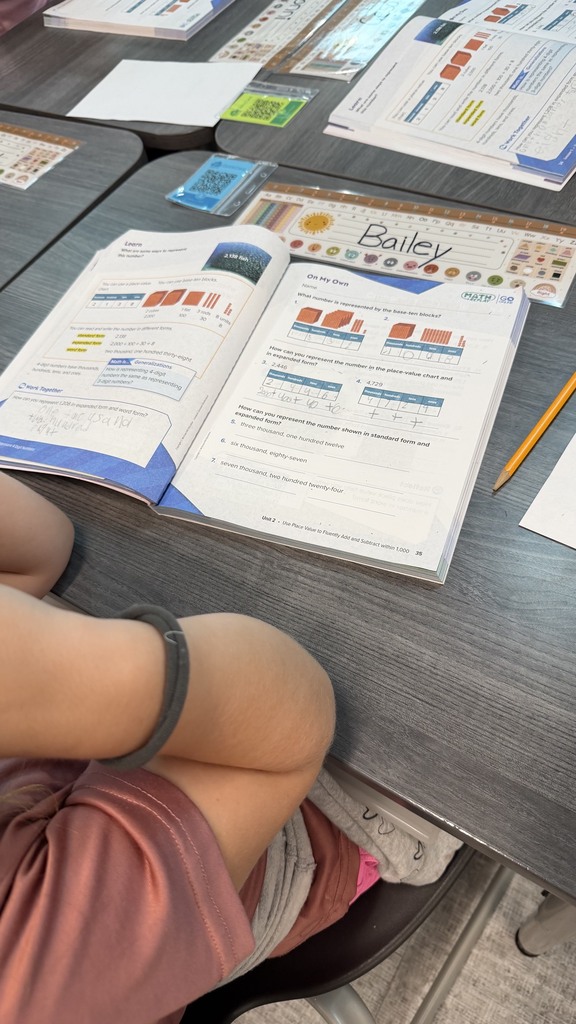 Third grade student working on representing numbers in standard and expanded form.