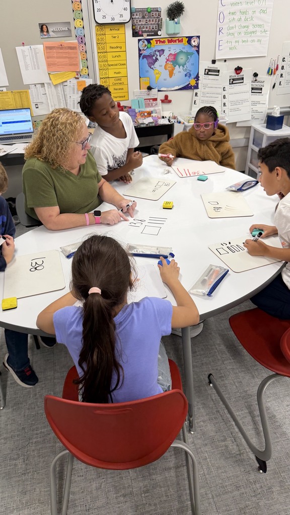 Third grade students working on showing numbers using place value blocks.