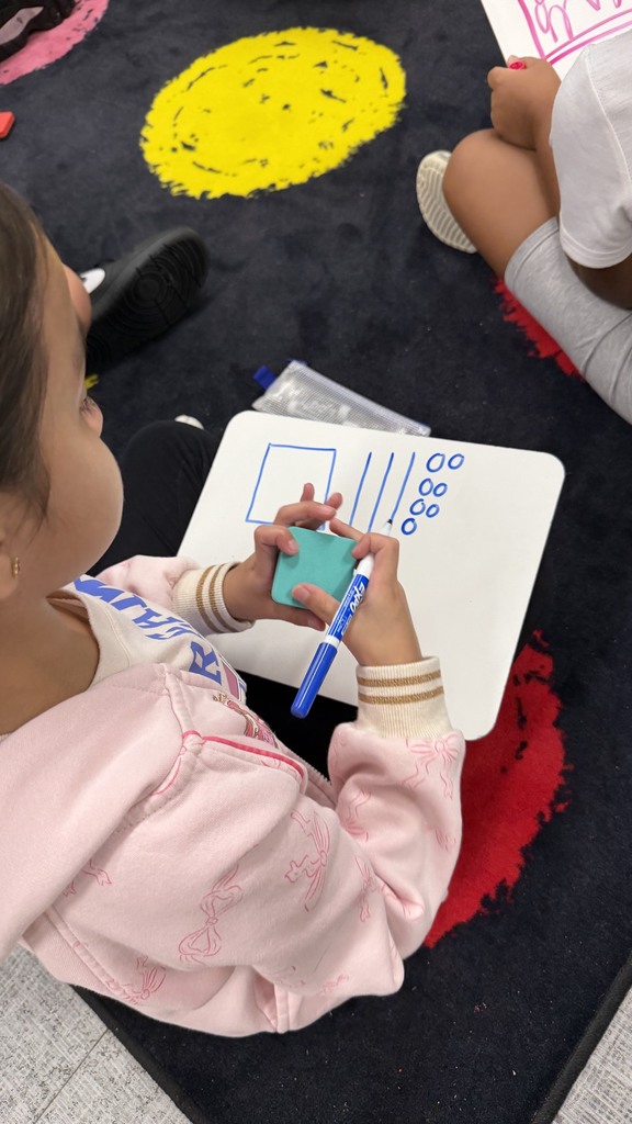 Third grade student representing a number using base ten blocks.