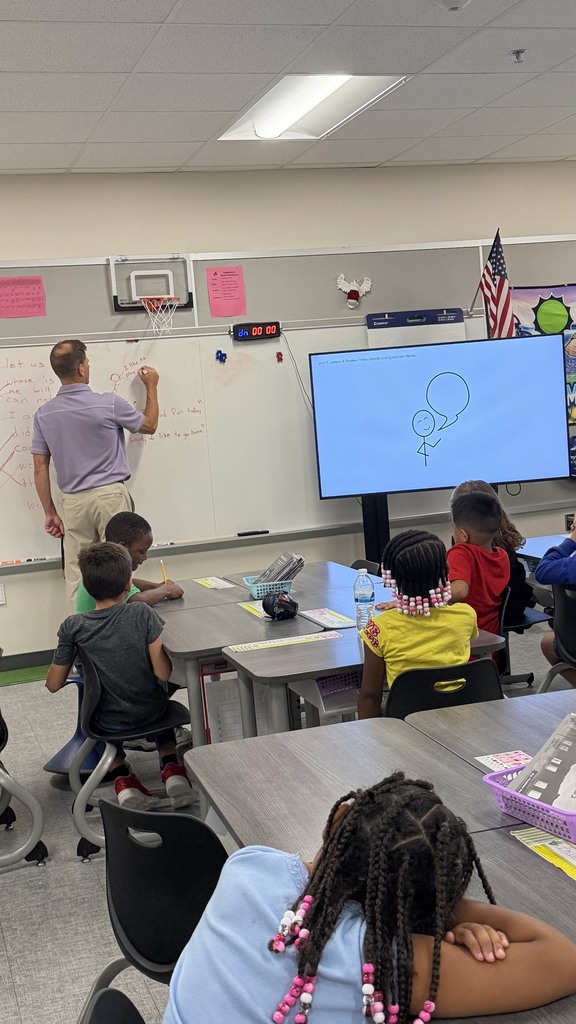 2nd grade students working on writing sentences with quotation marks.