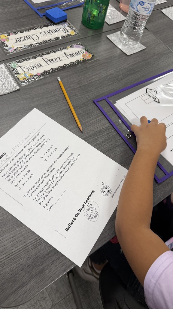 2nd grade students using word problem strategies to answer their exit ticket.