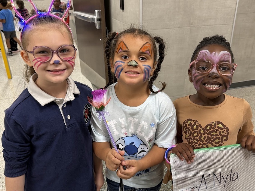 three girls with faces painted