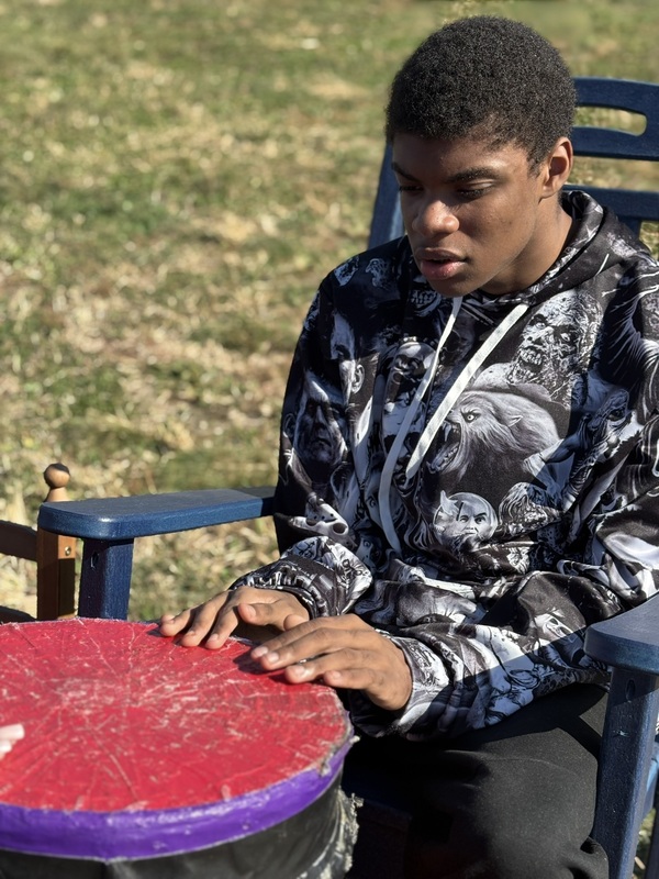 Student S. Sharaad places drums