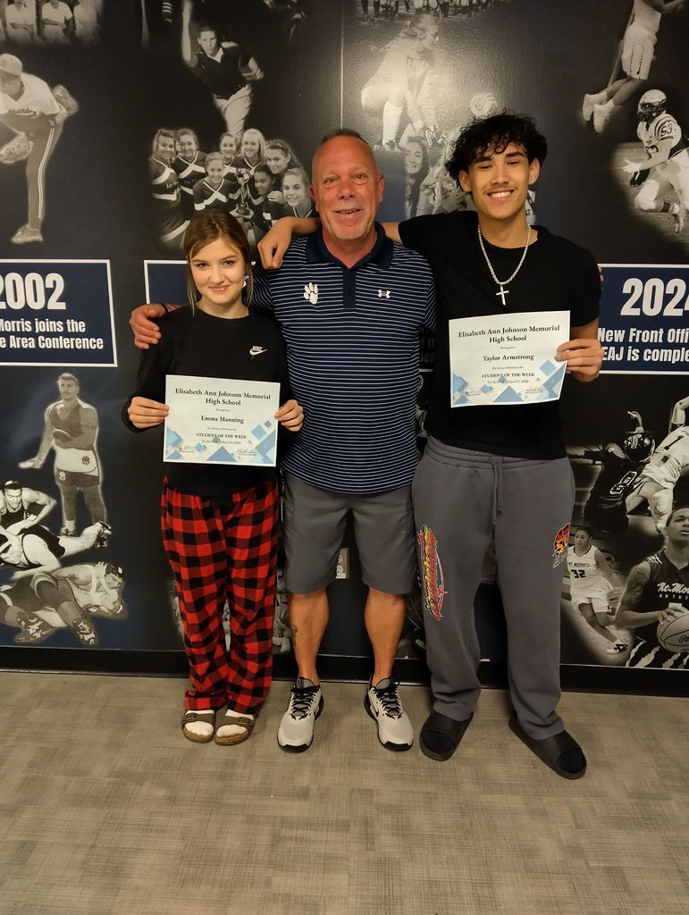 Students of the Week Taylor Armstrong(right) and Emma Manning(left) pose with Mr. Dave(center) in front of the athletic mural with their Student of the Week Certificates.