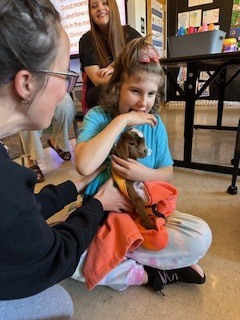 Student holding goat