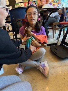 Student holding goat