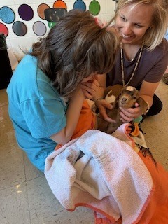 Student holding goat