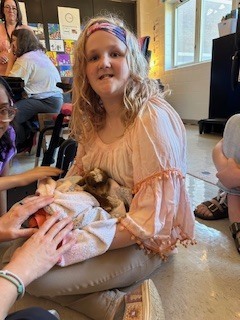 Student holding goat