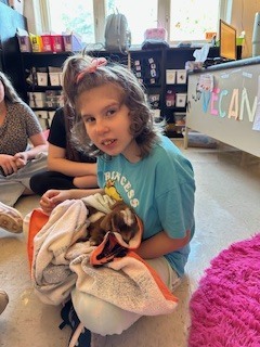 Student holding goat