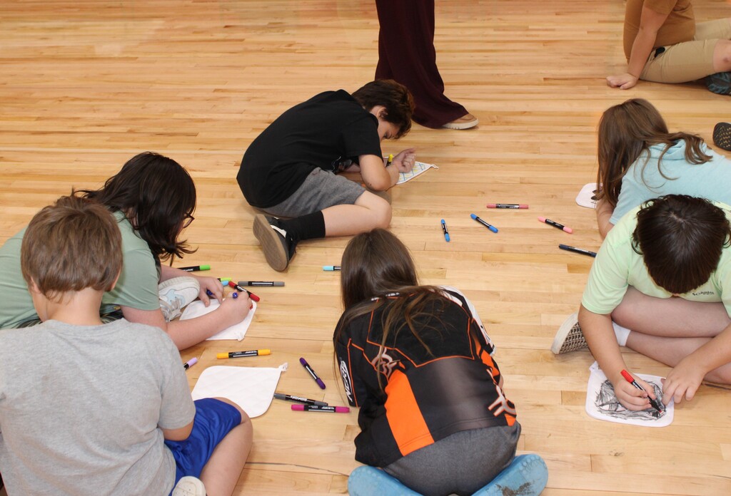 Students coloring potholders