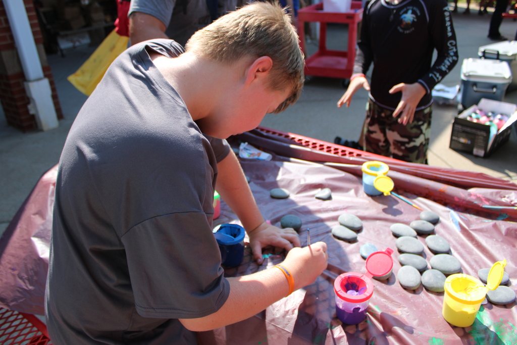 student painting rock