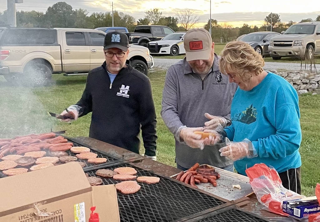 Mr. Lile and board members grilling
