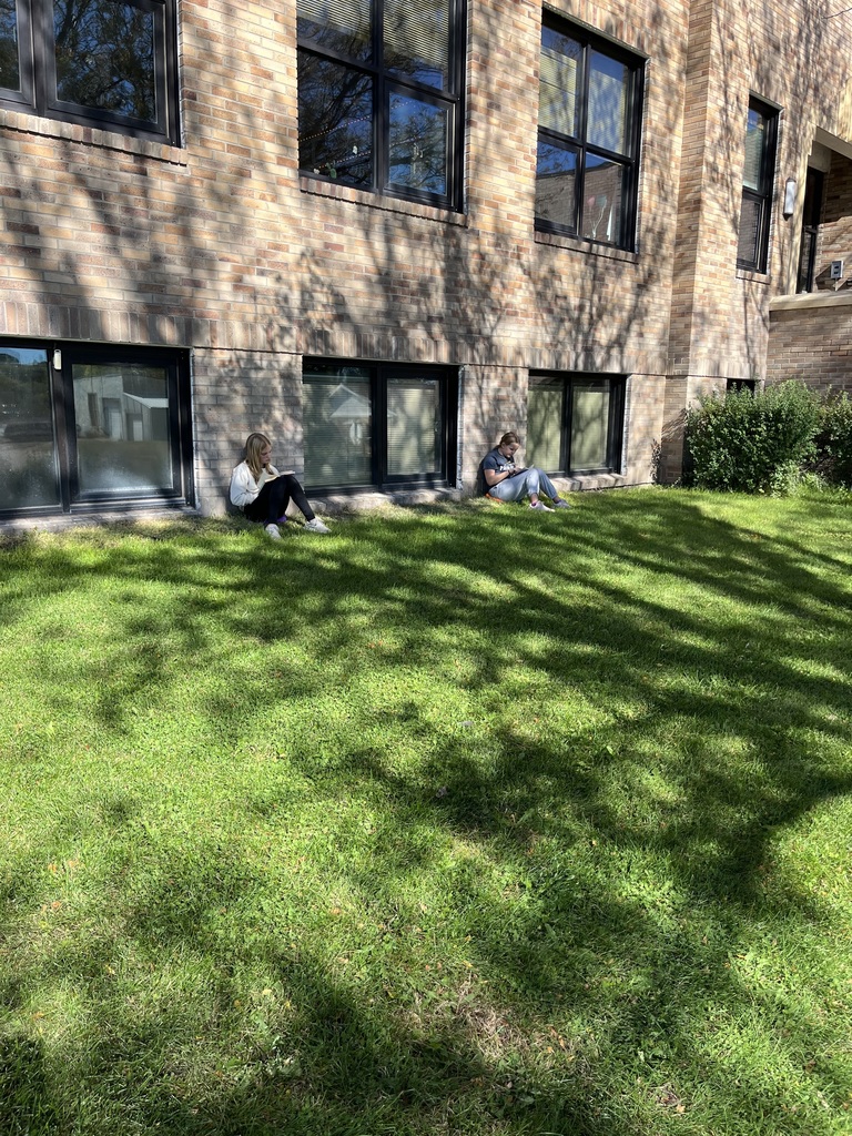 students reading outside