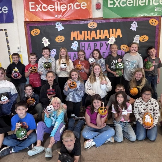 4th and 5th graders with their painted pumpkins