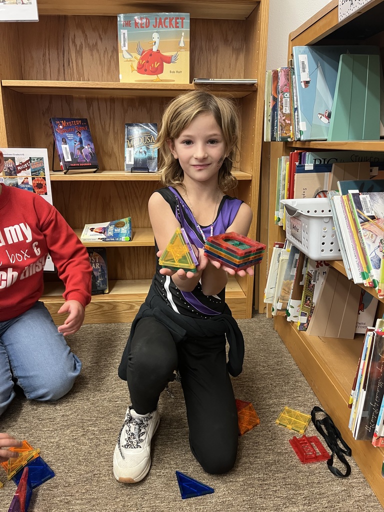Children building with magnetic tiles