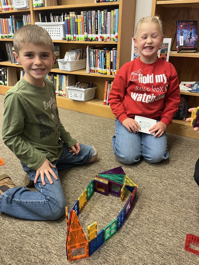 Children building with magnetic tiles