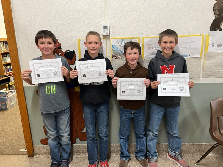 4 students holding their certificates 