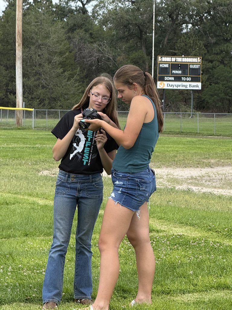 Two students looking at camear