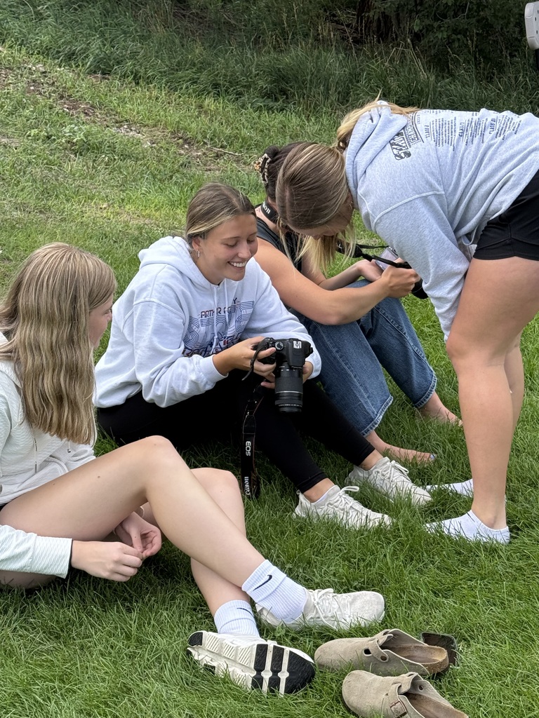 Four girls looking at cameras