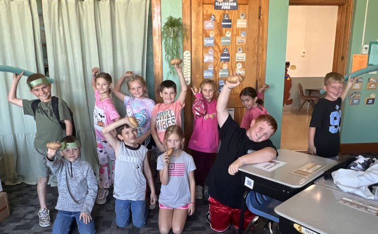 2nd graders pose with their javelins (pool noodles) or shot puts (potatoes)