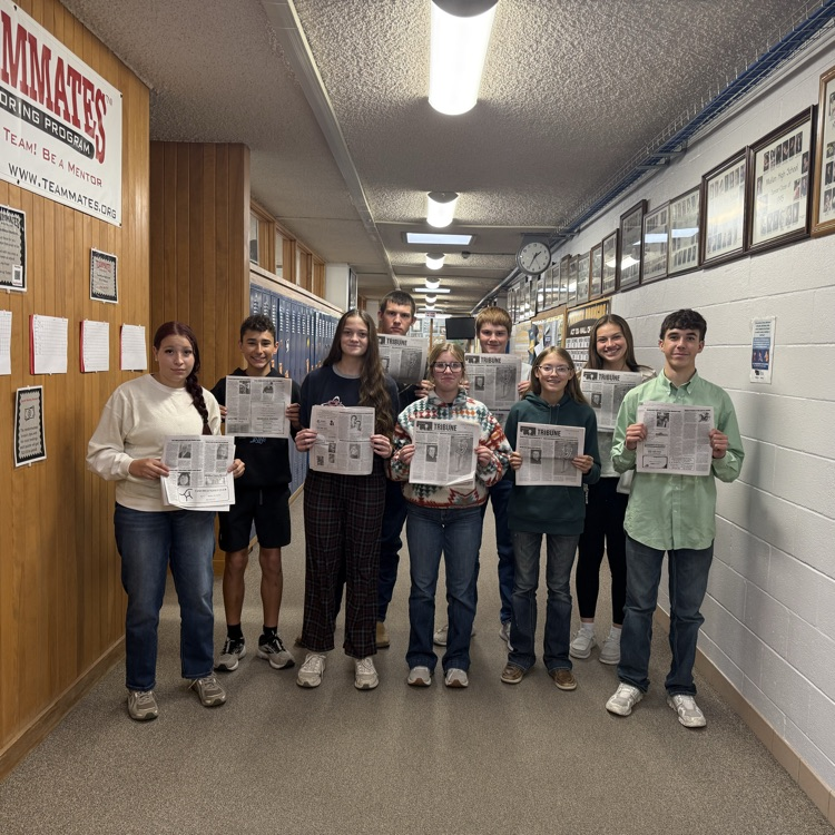 students holding newspapers