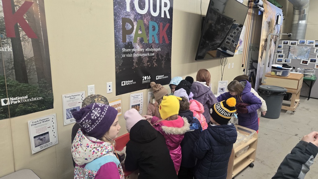 Today our 1st graders from Mrs. Murk’s and Mrs. LaFlamme’s classes had an amazing hands-on learning adventure at the learning center at Pictured Rocks National Lakeshore ❄️🌲  Students explored winter habitats and discovered how animals survive in cold weather. They learned how to identify animal tracks in the snow, practiced observation skills like young scientists, and even experienced snowshoeing as part of their outdoor learning day.  Real-world learning + fresh air + curiosity in action = a fantastic day for our young explorers. Thank you to our staff and park educators for making this experience meaningful and memorable for our students!