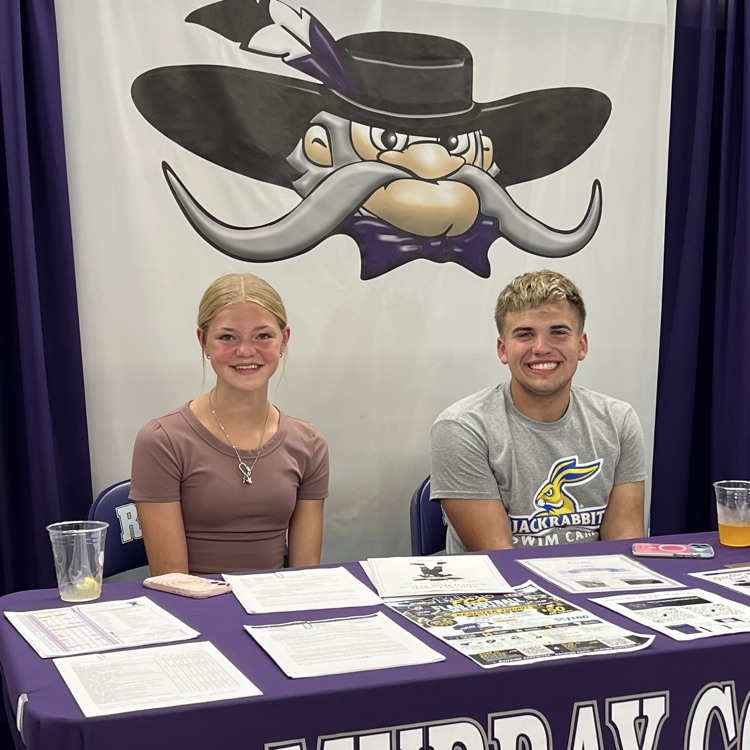 Student council members sitting at the fair booth.