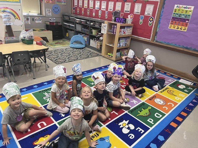 A picture of students in colored crowns