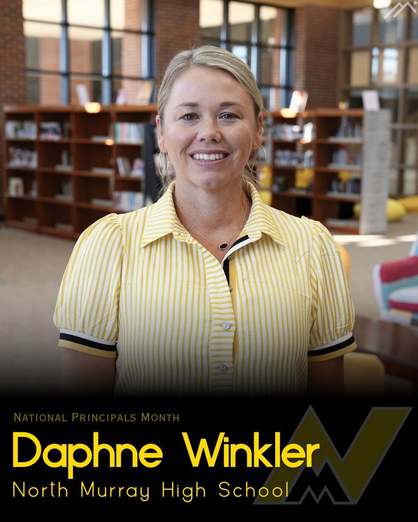A woman smiles, standing in a room with bookshelves and a bright backdrop, wearing a yellow and black shirt. Text reads "National Principals Month" and "Daphne Winkler, North Murray High School."