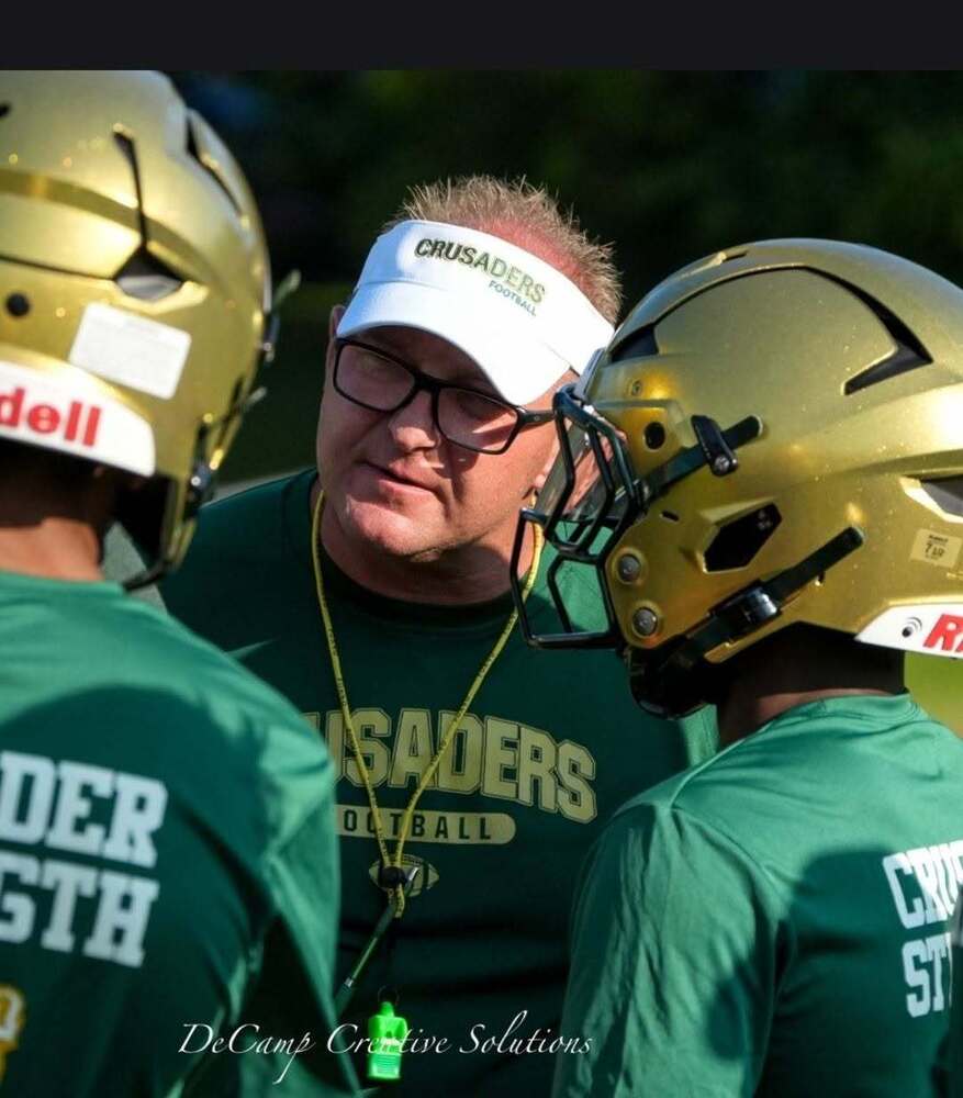 Coach talking to football players