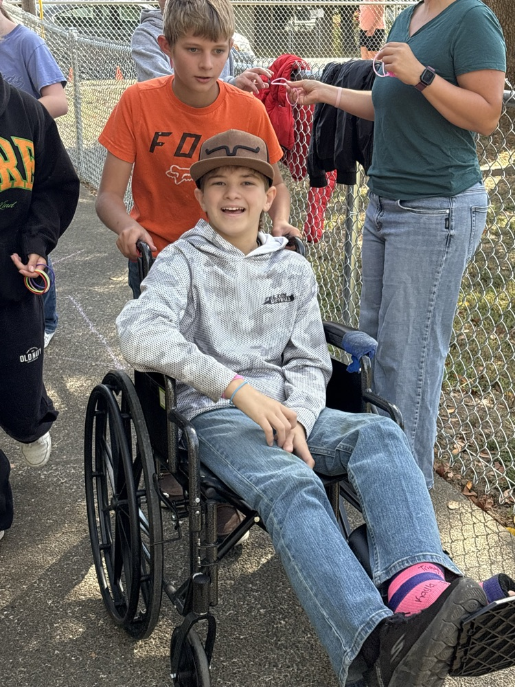 injured student being pushed in a wheelchair