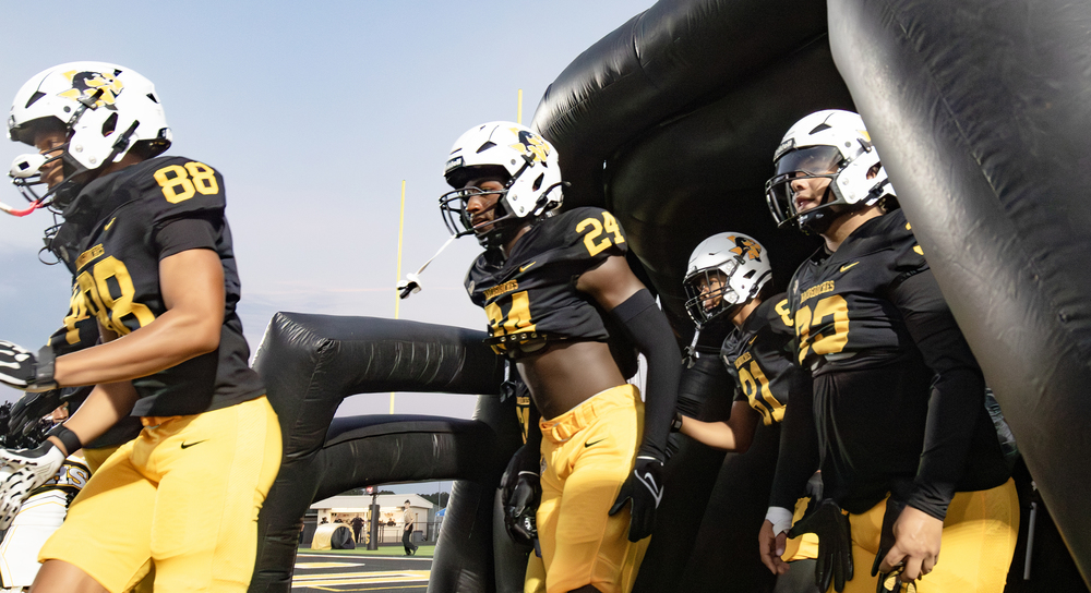 Dragons football players enter the field