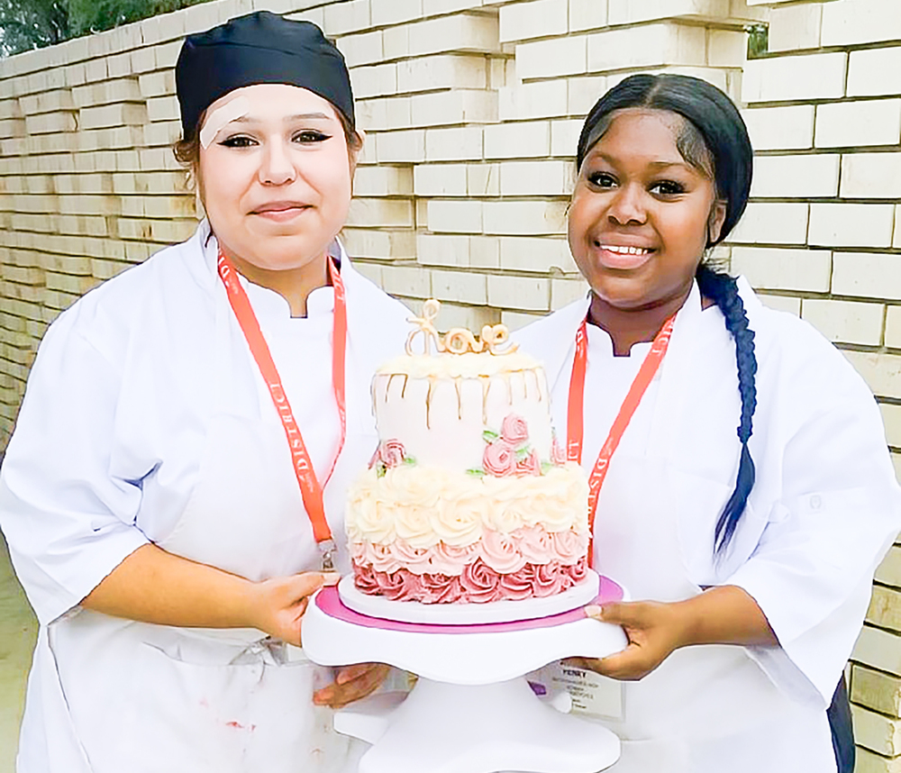 Students holding cake
