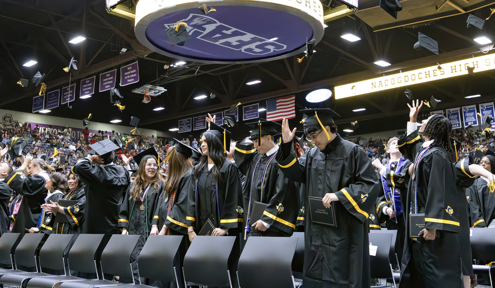 Graduates toss their hats in the air