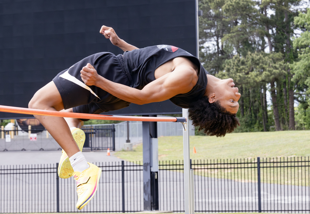 Micah Lockett goes over the high jump bar at Dragon Stadium