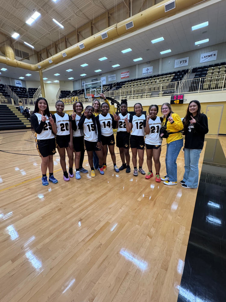 8th Grade McMichael Lady Dragon Basketball players in a group photo with coaches and manager