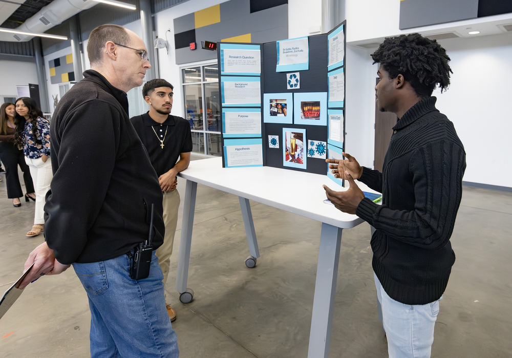 Judge talking with two science fair participants