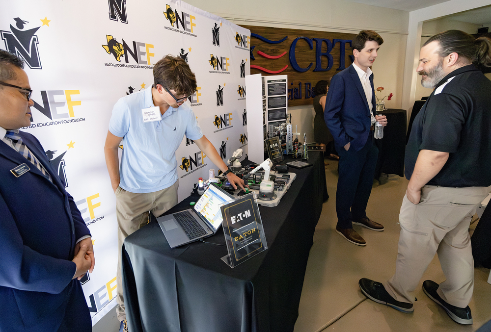 NHS teacher describes robotic arm donated to CTE program.