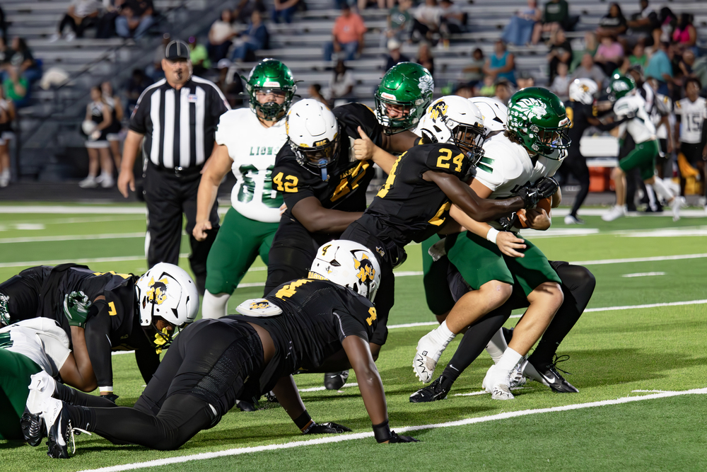 Dragons players make a tackle against Livingston