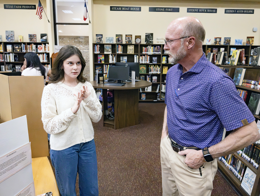 Student explains project to adult