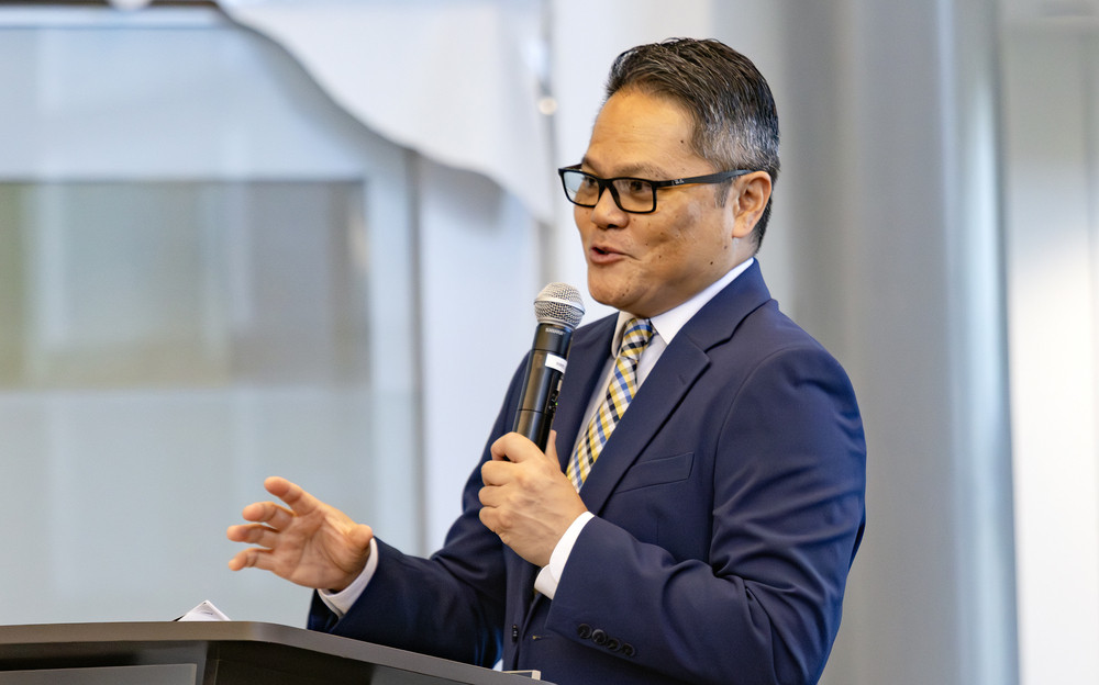Shawn Lucena speaking at podium